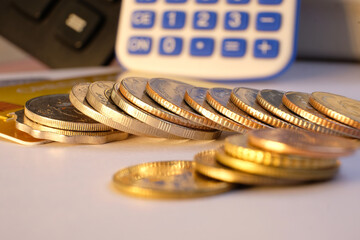 Poster - Close-up of a coin stack on a table with a business or finance saving money.