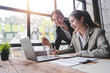 © Daenin - Young colleagues discussing business and price chart analyzes business people on the table great in modern coworking office teamwork concept.
