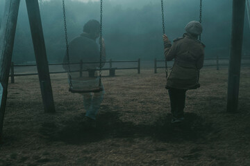 concept of afterlife and memory for parents or lost love. back view of woman sitting on a swing with