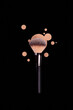 © Тарас Белецкий - Professional brush with black handle for make up with drops of beige foundation, bb cream isolated on black
