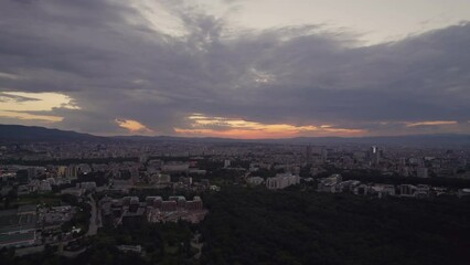 Wall Mural - Urban landscape of twilight time with sun over the horizon