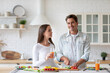 © BestForYou - Happy couple is preparing healthy food on light kitchen. Cooking together salad