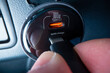 Close-up view of plugging in USB type C cable into a powerful car charger