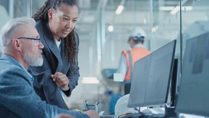 Leinwandbilder - Factory Office Facility: Industrial Engineers Drafting Blueprints of a Heavy Industry Machine Parts on a Computer CAD Software. African American Technician Discusses Work with Middle Aged Designer.