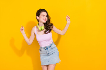 Poster - Portrait of cheerful carefree lady toothy smile enjoy dancing chilling isolated on yellow color background