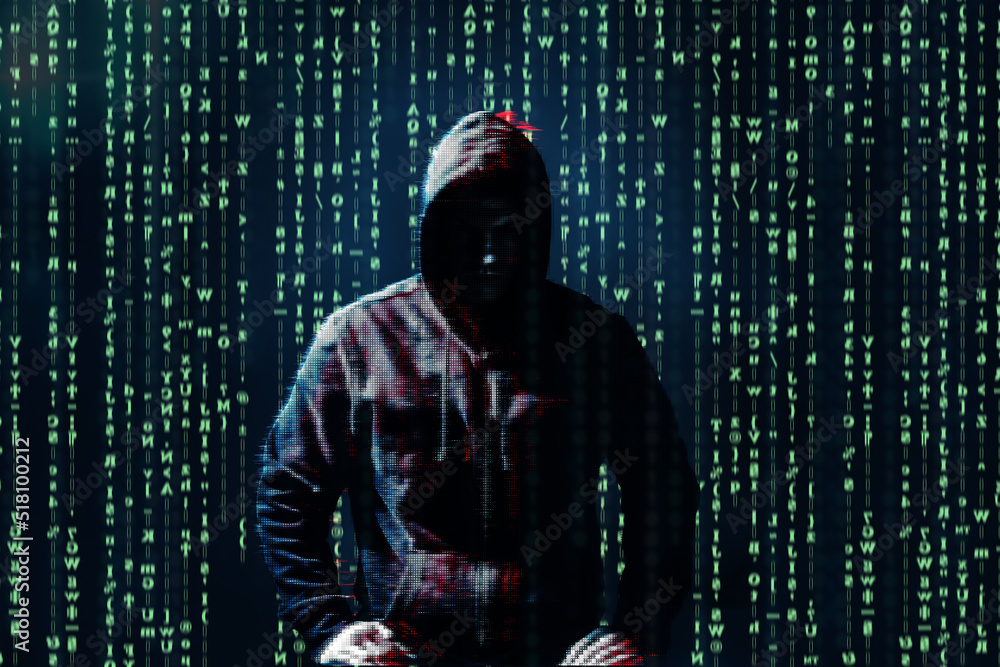 Silhouette of anonymous hacker and digital binary code on dark ...