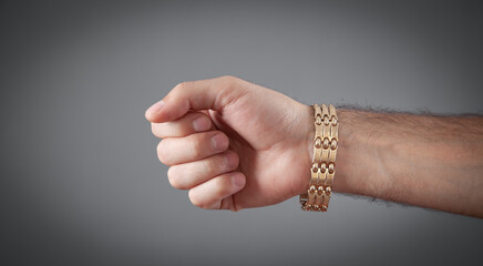 Male hand with a expensive bracelet. Fashion accessories and jewelry
