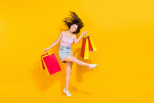 Full Length Portrait Of Carefree Positive Lady Hold Packages Have Good Mood Isolated On Yellow Color Background