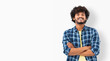 © kucherav - Young Indian male student smiling joyfully standing on a white background. Asian man in casual clothes with curly hair and happy smile