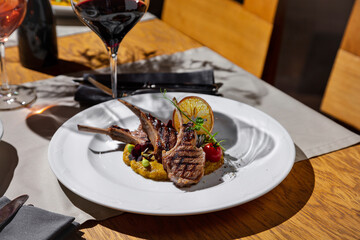 Sticker - Fried meat on the bone with tomatoes, pea sprouts, lime, mung bean salad and mashed potatoes