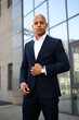 © Dmytro Hai - Portrait of african american businessman adjusting jacket on street