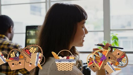 Poster - Animation of easter baskets over caucasian woman using smartphone in office