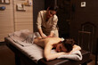© Dragosh - A young caucasian woman having a back massage treatment. Spa and healthy concept.
