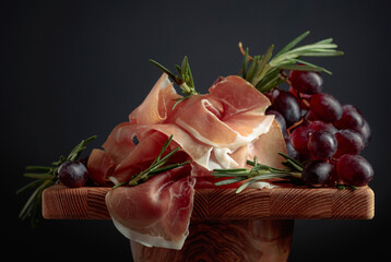 Wall Mural - Prosciutto with grapes and rosemary.