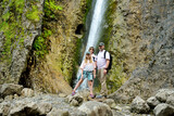 Father and his two daughters admiring Siklawica Waterfall in Strazyska Valley in Tatra Mountains, Poland.