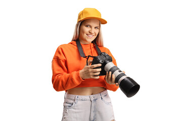 Canvas Print - Young trendy female holding a professional camera