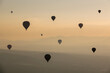 Group of Hot Air Balloons Flying Over Ancient Pyramid of Teotihuacan, Mexico at sunrise -sunset, over the mist