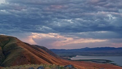 Wall Mural - Time lapse of clouds moving at sunset over Utah Lake and West Mountain as storm moves in.