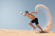 © JBLostada - Powerful athletic man sprinting on desert sand dunes with dramatic sand trail