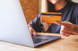 © Farknot Architect - Closeup image of a woman holding credit cards while using laptop computer for online payment