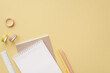 School supplies concept. Top view photo of stationery copybooks ruler pens stapler and adhesive tape on isolated pastel yellow background with empty space