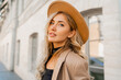 © Svetlana Sokolova - Close up  outdoor  portrait  of stylish blond woman with perfect wavy hairs in beige hat and casual suit. Full lenght.