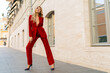 © Svetlana Sokolova - Profeshional fashion model in  elegant red velvet suit posin outdoor in old european city.  Full lenght.