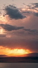 Wall Mural - Timelapse of sunset glowing in the sky as storm rolls in at dusk overlooking Utah Lake during summer monsoon.