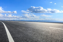 Asphalt Highway And Mountain Under Blue Sky. Empty Road And Mountain Nature Background.