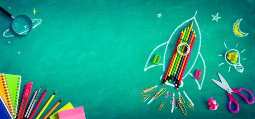 back to school - rocket with colorful pencils and blackboard - startup concept