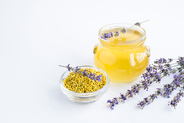 Wall Mural - Bee pollen, honey and lavender flower on the white background. Closeup. Copy space.