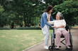 © Prot - Asian careful caregiver or nurse taking care of the patient in a wheelchair.  Concept of happy retirement with care from a caregiver and Savings and senior health insurance, a Happy family