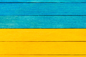 Wall Mural - Wooden textured boards in blue and yellow colors . Blue and yellow separated wooden background. 