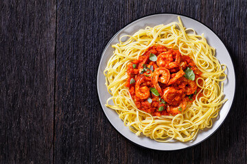 Sticker - shrimps in tomato sauce with pasta, top view