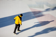 Man On Ice Rink In Millennium Park Of Chicago Downtown.