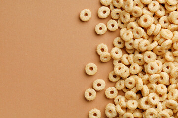 Wall Mural - Cornflakes rings for breakfast on a brown background. Copy space for text.