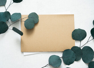 Wall Mural - Mockup for a letter or a wedding invitation with leaves eucalyptus branches.	