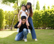 © atitaph - Asian family happy bright cute daughter is resting by playing in the grass let daughter ride father's neck