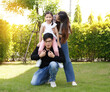 © atitaph - Asian family happy bright cute daughter is resting by playing in the grass let daughter ride father's neck