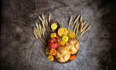 Wall Mural - Wiccan Altar for Lammas, Lughnasadh pagan holiday. ears of wheat, homemade bread, flowers, apple, candle on dark background. symbol of celtic wiccan sabbath, harvest. top view