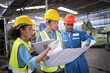 © FotoArtist - Three Heavy Industry Engineers Stand in Pipe Manufacturing Factory, Use Digital Tablet Computer, Have Discussion. Design and Construction