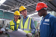 © FotoArtist - Three Heavy Industry Engineers Stand in Pipe Manufacturing Factory, Use Digital Tablet Computer, Have Discussion. Design and Construction