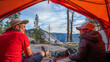© spatesphoto - Two happy campers inside a tent on a cliff overlooking Yosemite Valley