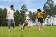 © Bo Bo/Stocksy - asian family with dog in the park