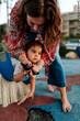 © Erin Brant/Stocksy - Mother testing daughter's glucose with meter