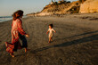 © Erin Brant/Stocksy - Joyful girl running toward mother on beach
