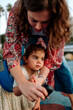 © Erin Brant/Stocksy - Mother testing girl's blood with glucometer