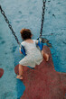 © Erin Brant/Stocksy - Back of girl swinging on stomach