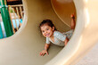 © Erin Brant/Stocksy - Happy young girl in tube slide