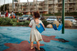 © Erin Brant/Stocksy - Back of girl standing at playground